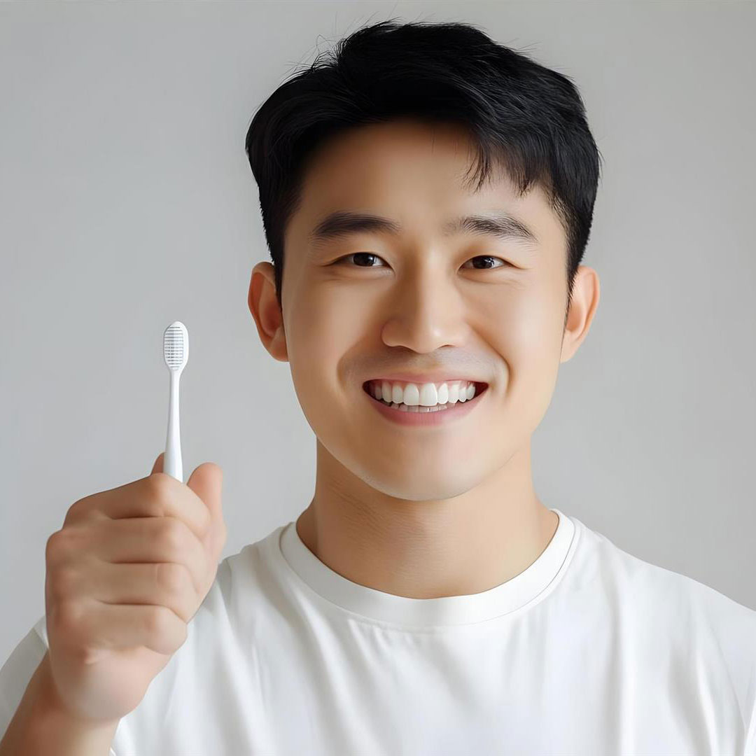 Man-holding-toothbrush-and-smiling-with-white-teeth