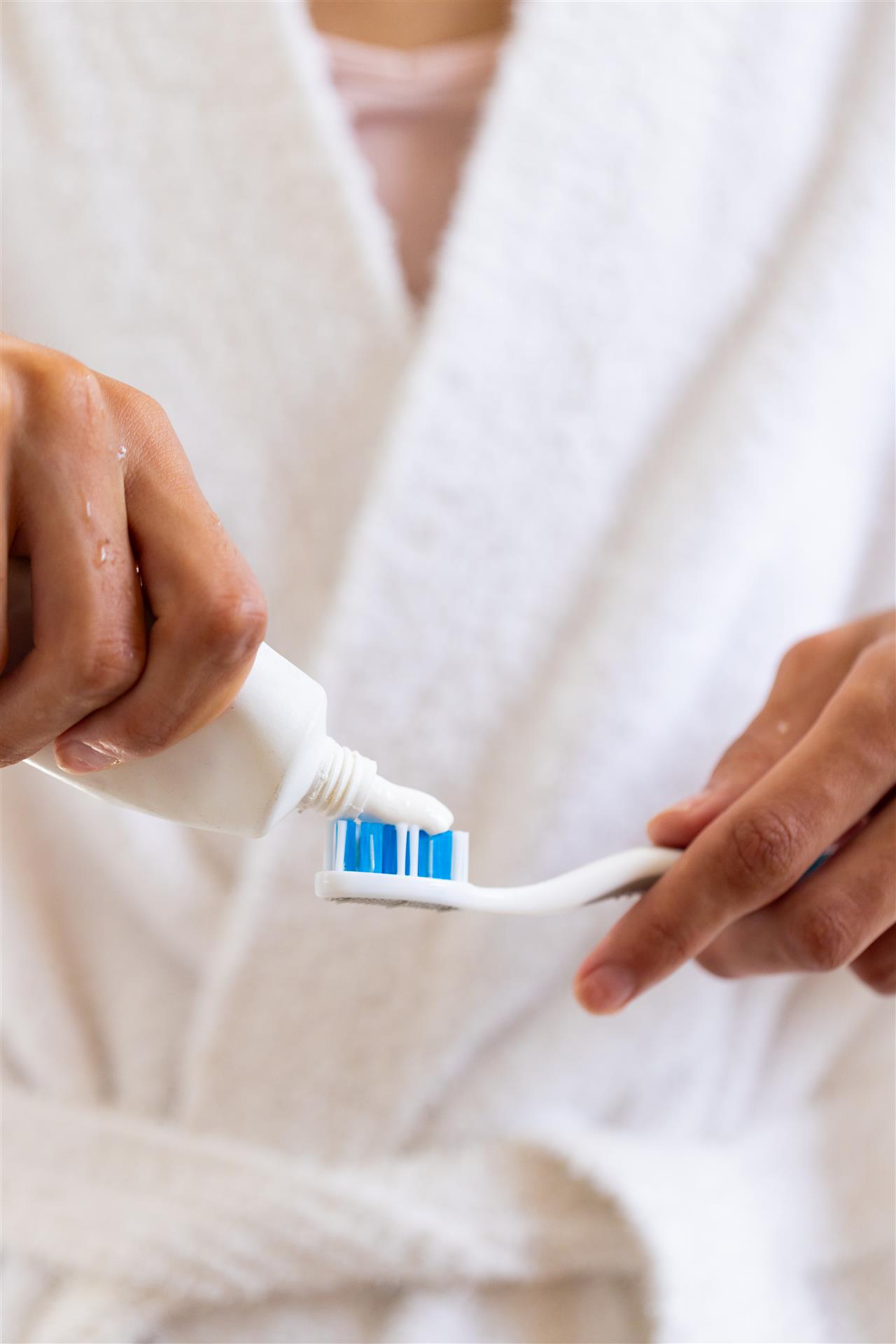 applying-toothpaste-toothbrush-young-man-bathrobe-preparing-brushing-teeth (Custom)